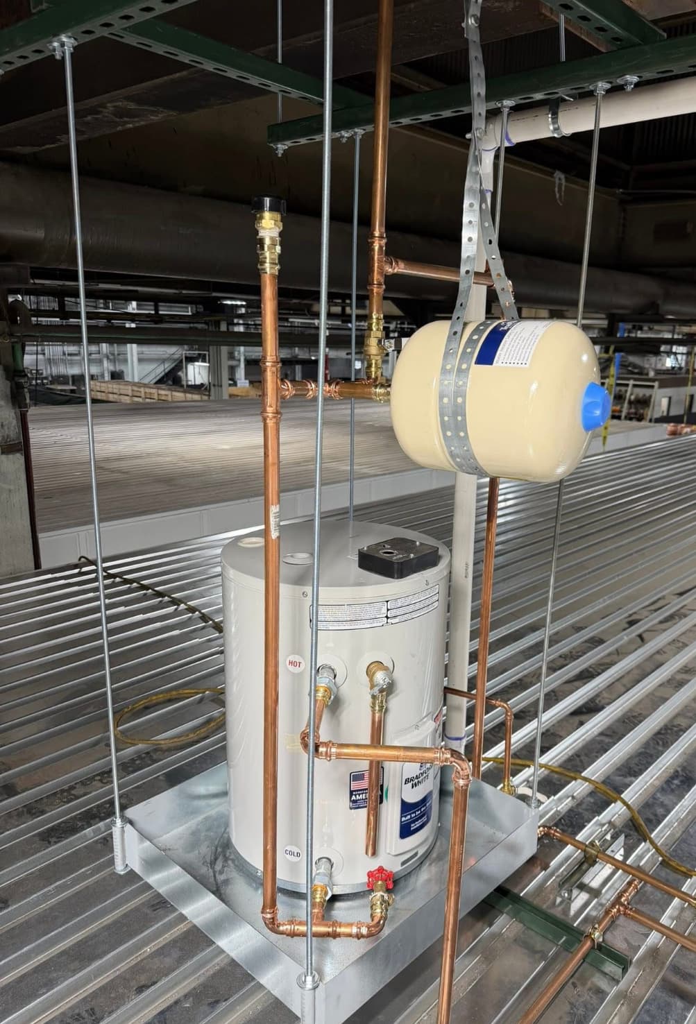 Compact water heater installation with copper piping and expansion tank in a Leawood-area utility space